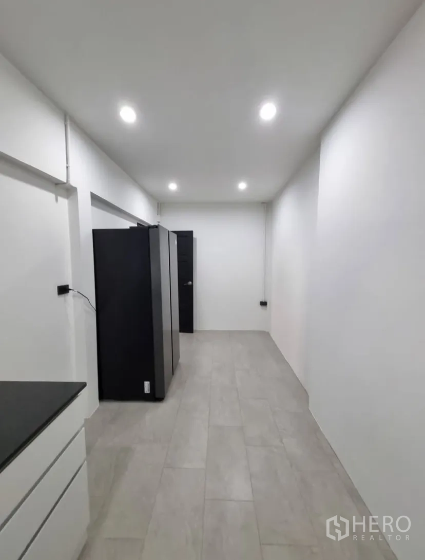 Detached House for rent in Suan Luang, Bangkok - Narrow utility or storage room with tiled floor and ceiling lights.