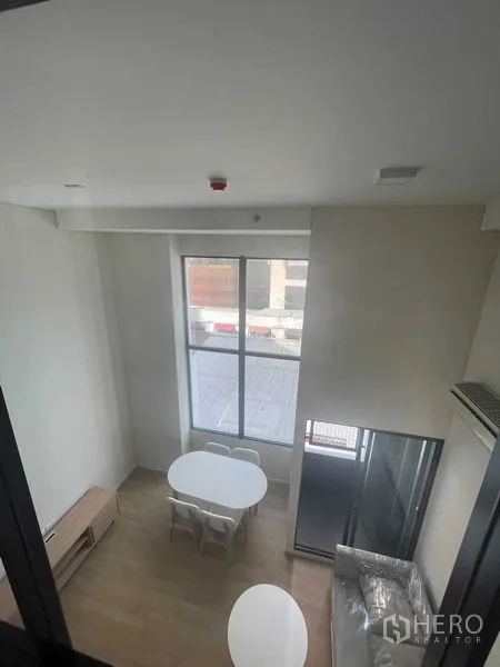 คอนโด ให้เช่าในKhlong Toei, Bangkok - มุมมองจากชั้นลอย เห็นชุดโต๊ะทานข้าวใกล้หน้าต่างสูง