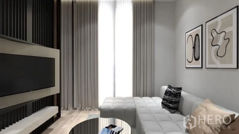 Condominium for rent in Watthana, Bangkok - Bright lounge with sectional sofa, wall-mounted TV and tall curtains.