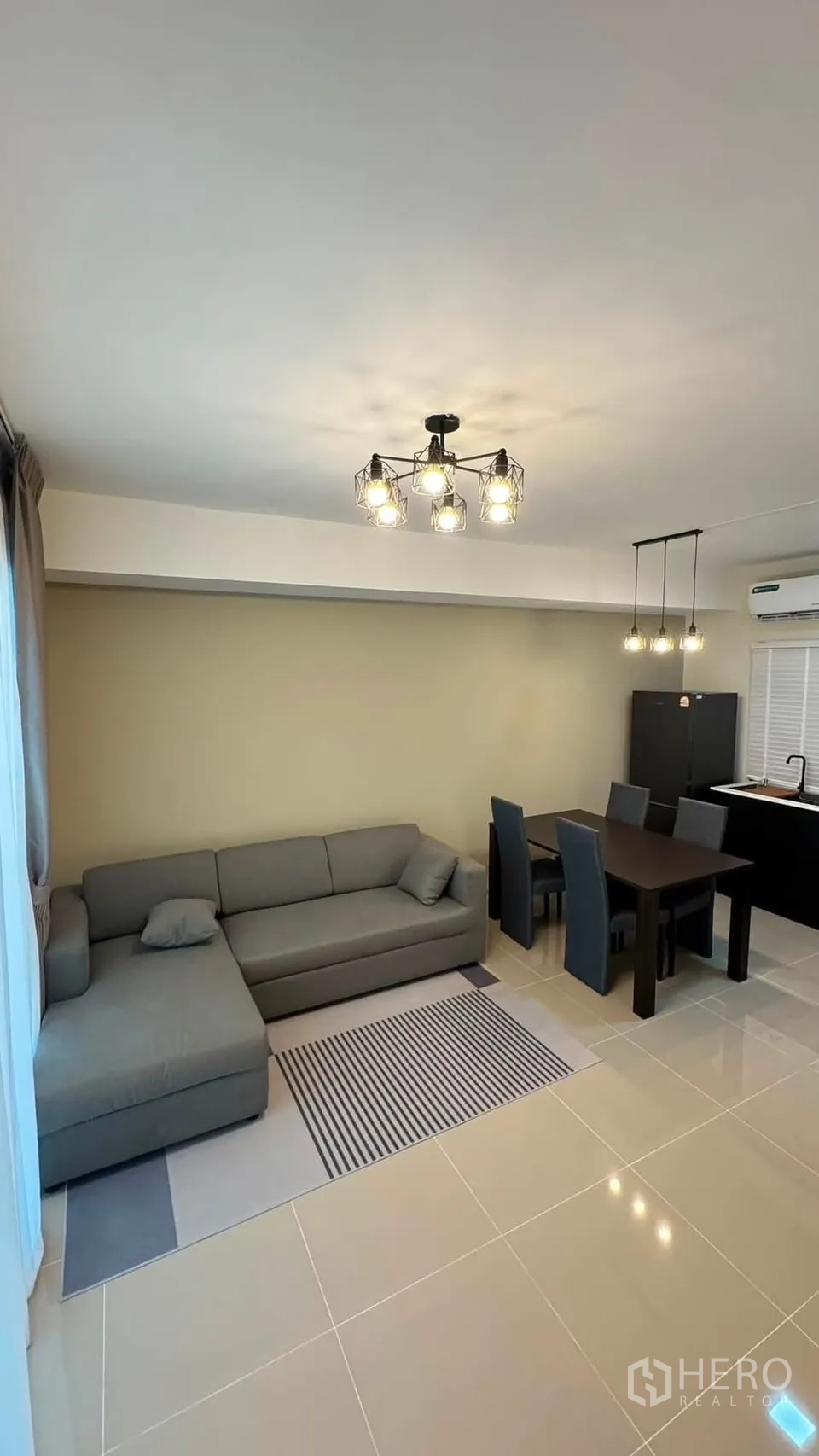 Townhouse for rent in Bang Phli, Samut Prakan - Another view of the living and dining space with sofa and dining table.