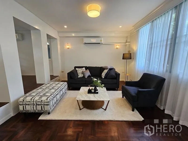 Detached House for rent - Formal sitting room with sofa set, ottoman, and recessed lighting for a cozy ambiance.