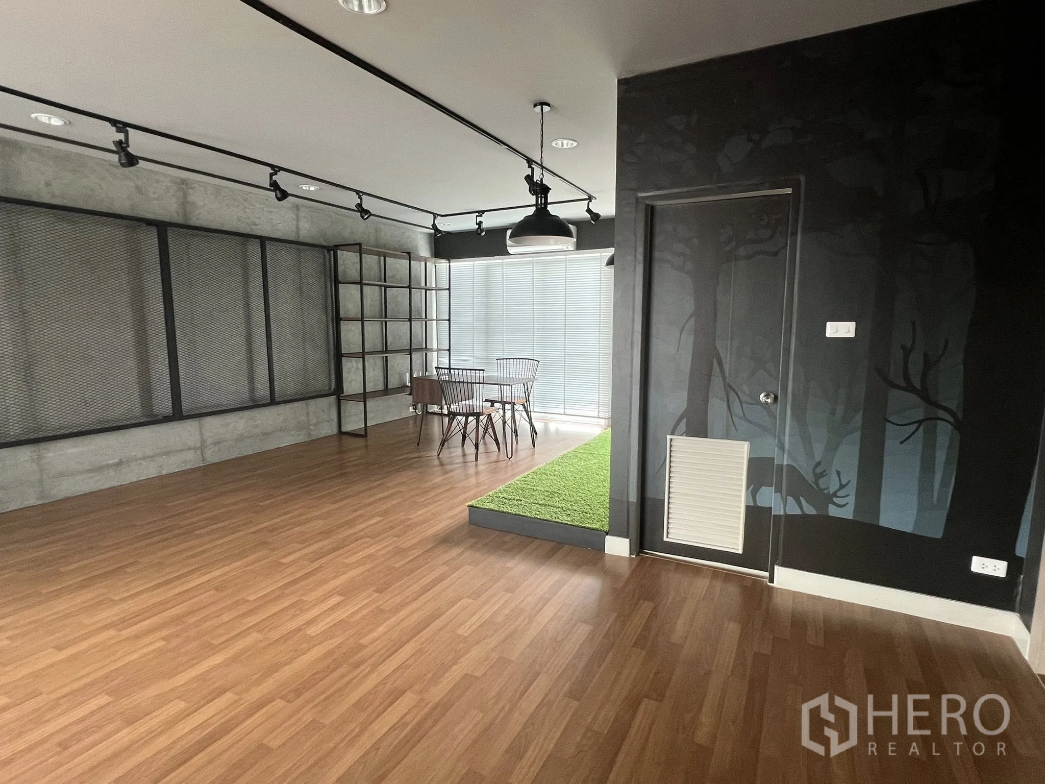 Detached House for rent or sale in Don Mueang, Bangkok - Office area with door, pendant light and green turf display.