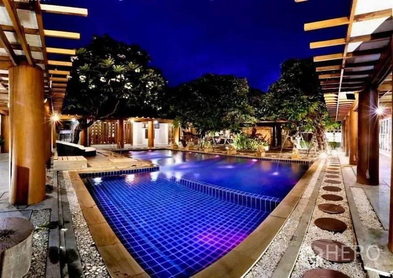 Detached House for sale in Bueng Kum, Bangkok - Resort-style pool at night with mood lighting, pergolas and garden seating.