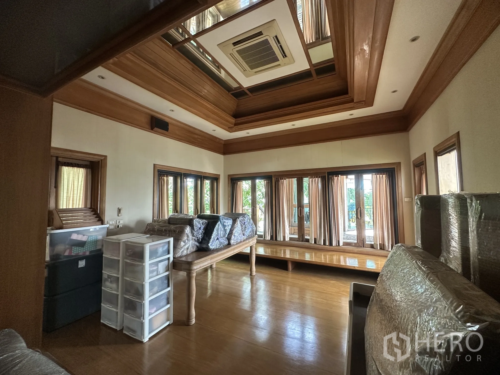 Detached House for rent in Lam Luk Ka, Pathum Thani - Multi-purpose room with wood ceiling, many windows, and doors to a terrace.