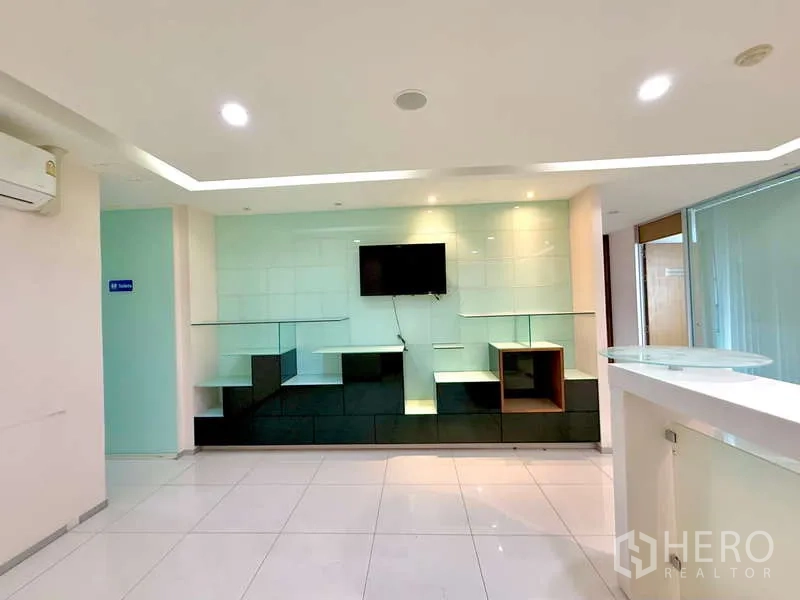 办公空间 出租在Chatuchak, Bangkok - 明亮大厅内的电视背景墙与白色接待台