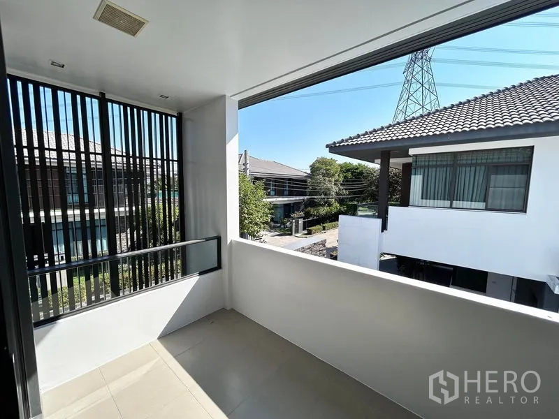 Detached House for rent or sale in Prawet, Bangkok - Covered upper-floor balcony with privacy screens and neighborhood view.