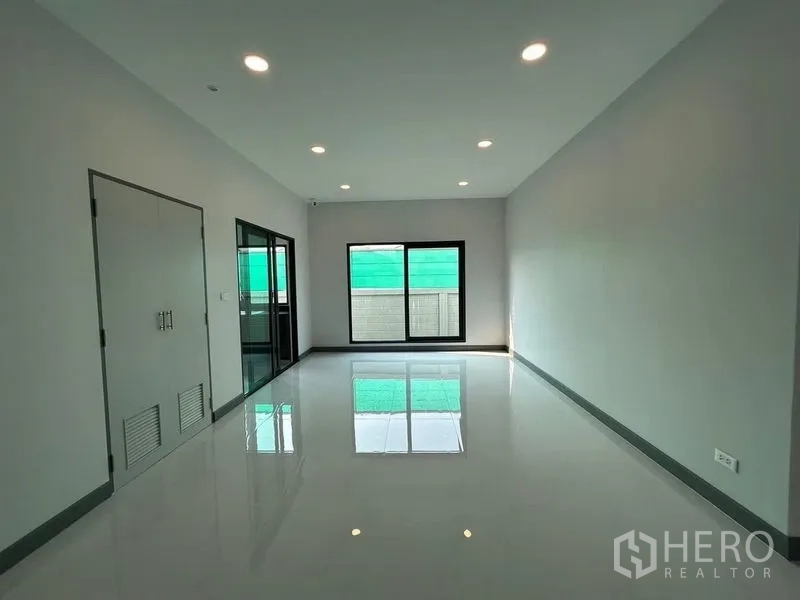 Detached House for rent - Another view of the upper living area with recessed lighting and balcony access.