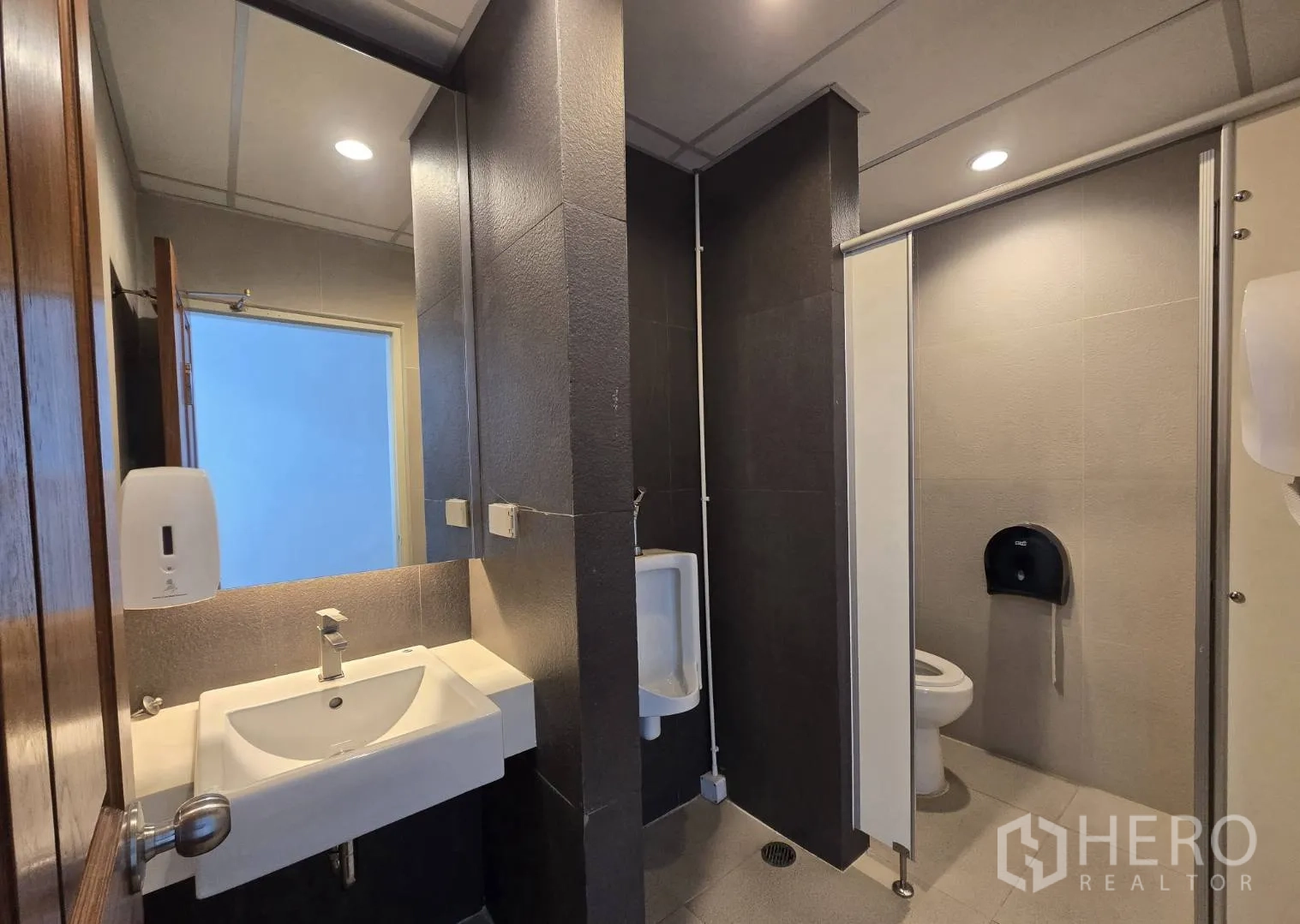 Office Space for rent in Watthana, Bangkok - Restroom with sink, urinal, and enclosed toilet cubicle.