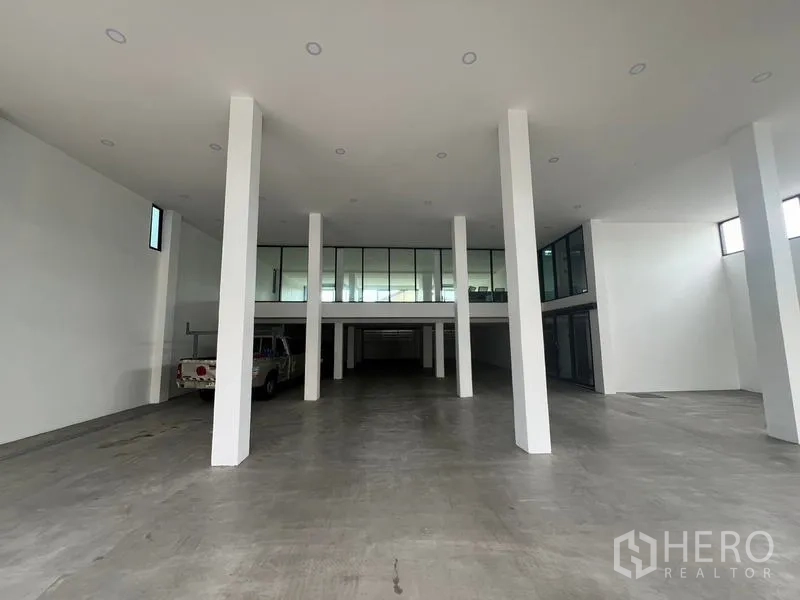 Office Space for rent or sale in Wang Thonglang, Bangkok - Covered parking hall with tall white columns and a mezzanine.