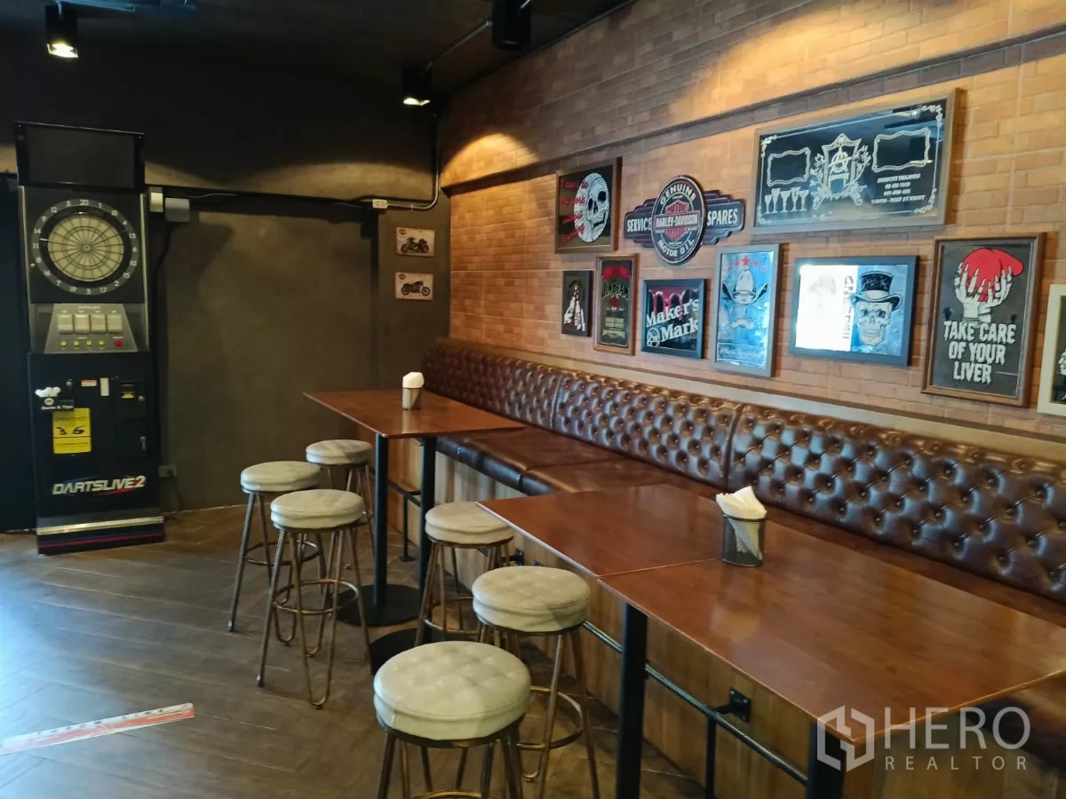 Retail Space for rent - Dart machine corner with long banquette, tables and industrial lighting.