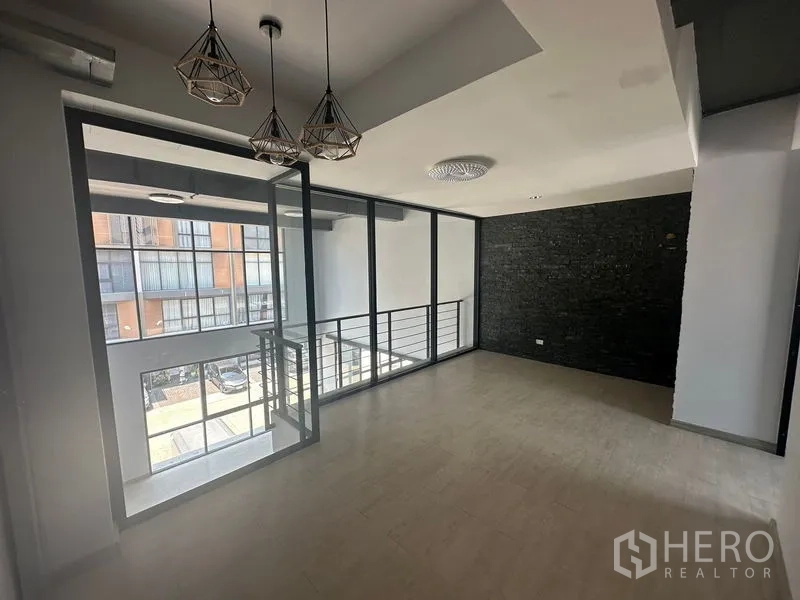 Home Office for rent - Mezzanine office area with pendant lights and a floor-to-ceiling glass partition.