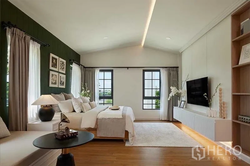 Detached House for sale in Bang Phli, Samut Prakan - Master suite with vaulted ceiling, TV wall unit, wood floors and twin windows.