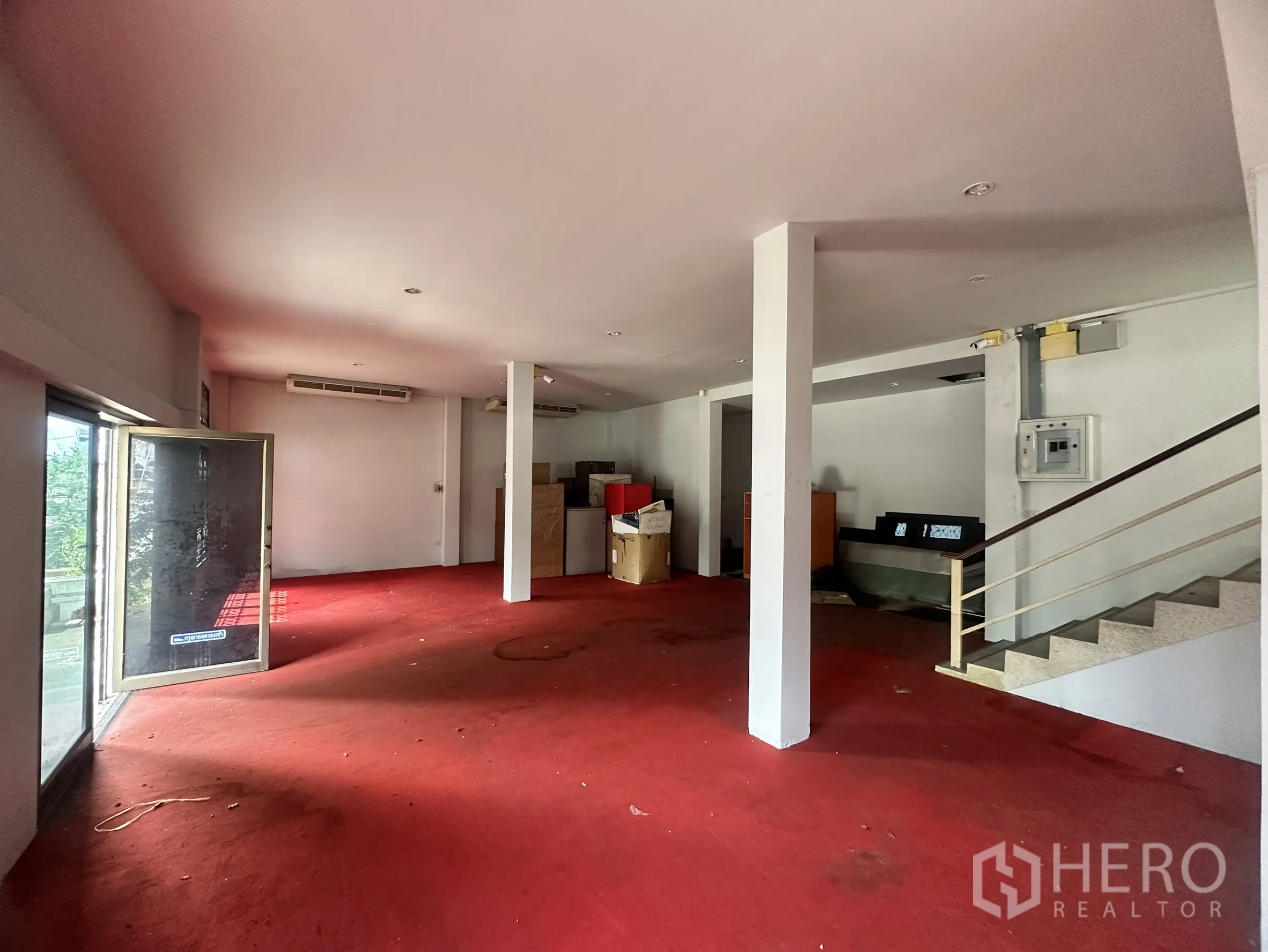 Factory for sale in Bang Bua Thong, Nonthaburi - Reception or showroom space with red carpet, glass entry, and staircase.