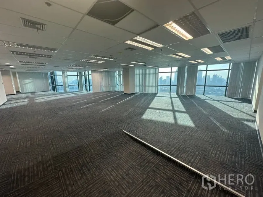 Office Space for rent in Watthana, Bangkok - Wide floor‑plate office with low‑glare lighting and city skyline at the windows.