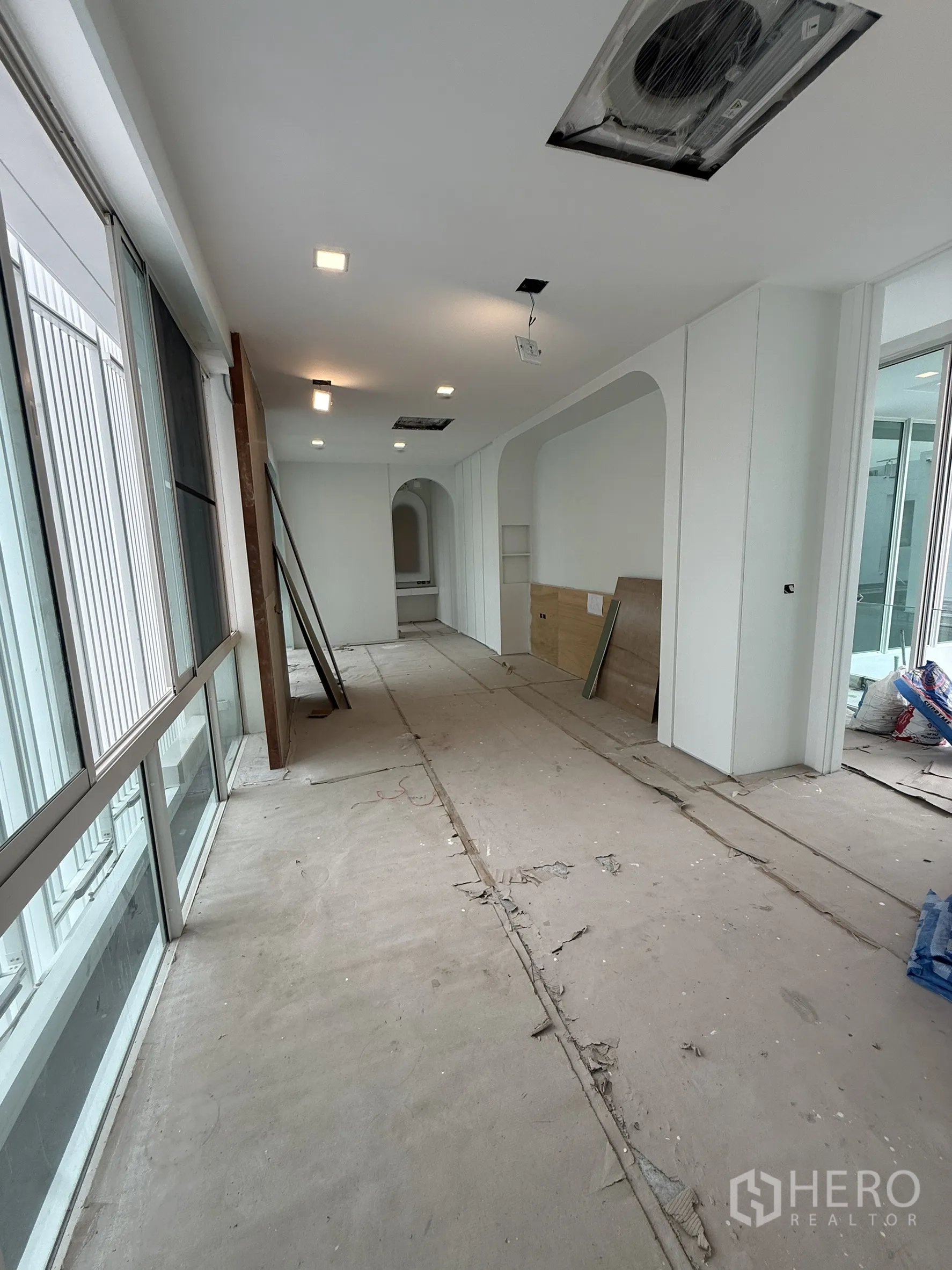 Detached House for sale in Bang Phli, Samut Prakan - Another angle of long corridor with glazing and ceiling AC vents.