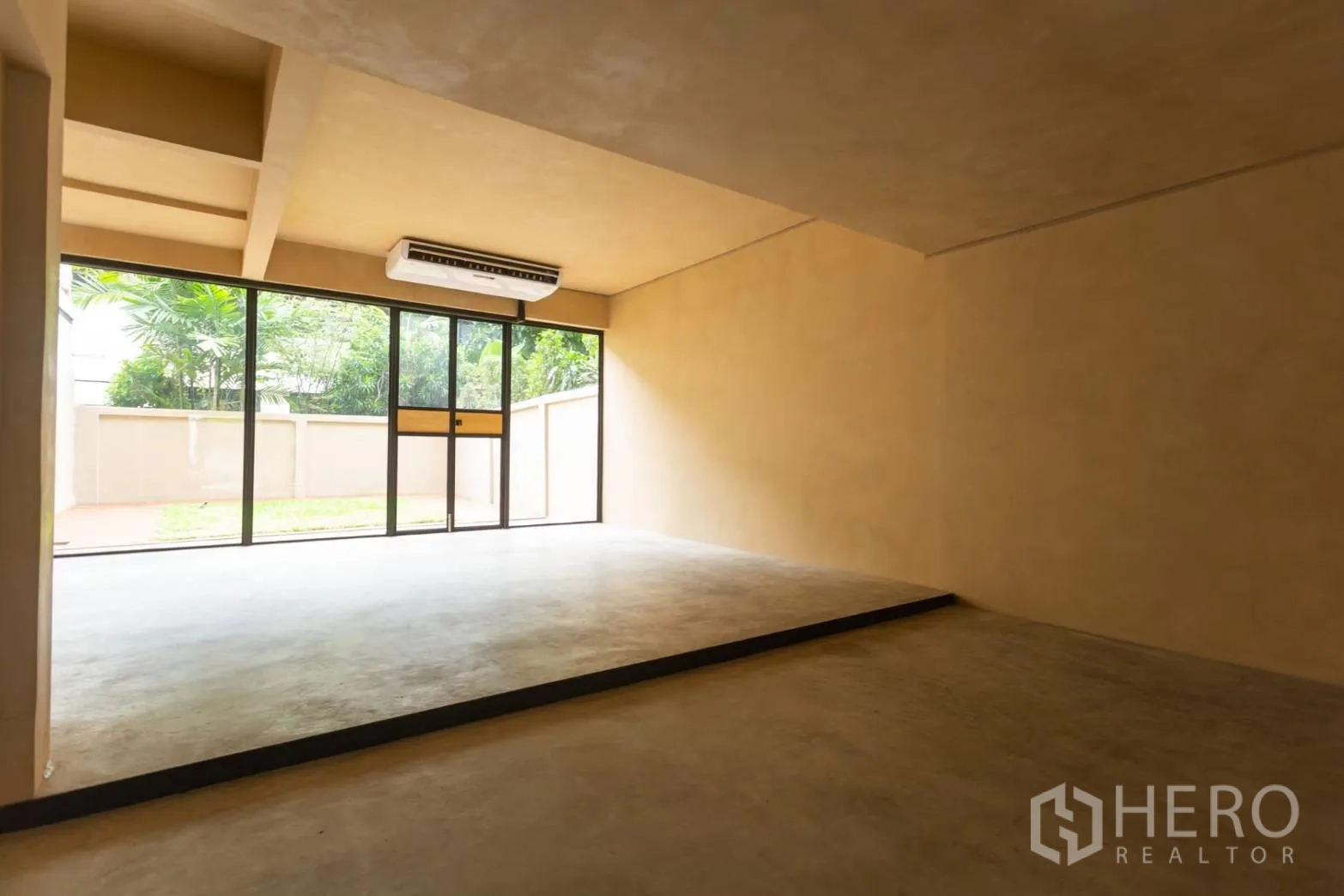 Home Office for rent in Watthana, Bangkok - Lower level room with raised platform, AC unit and sliding door to garden.