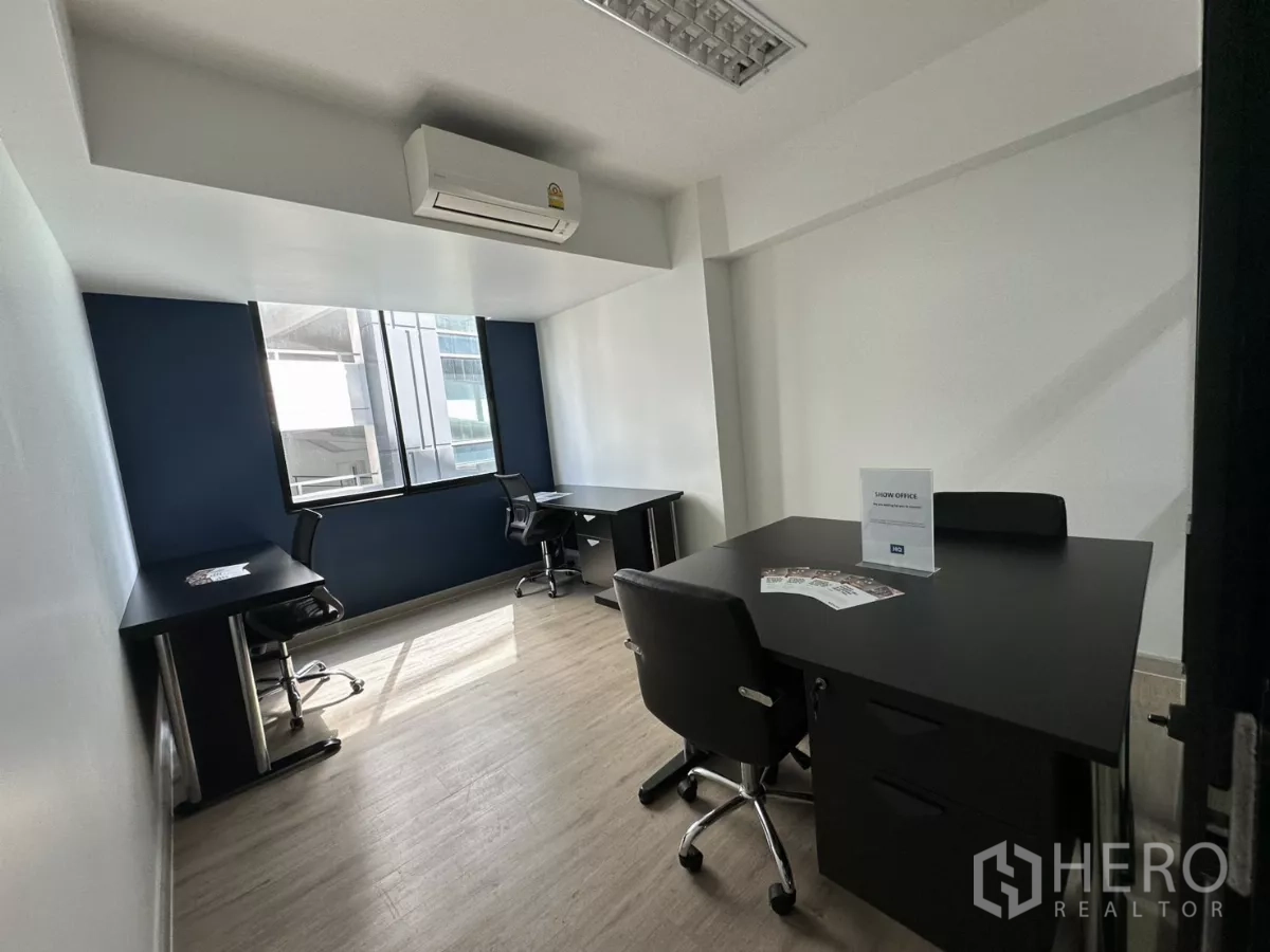 Office Space for rent in Watthana, Bangkok - Private office corner with AC unit, big window and black furniture suitable for four people.
