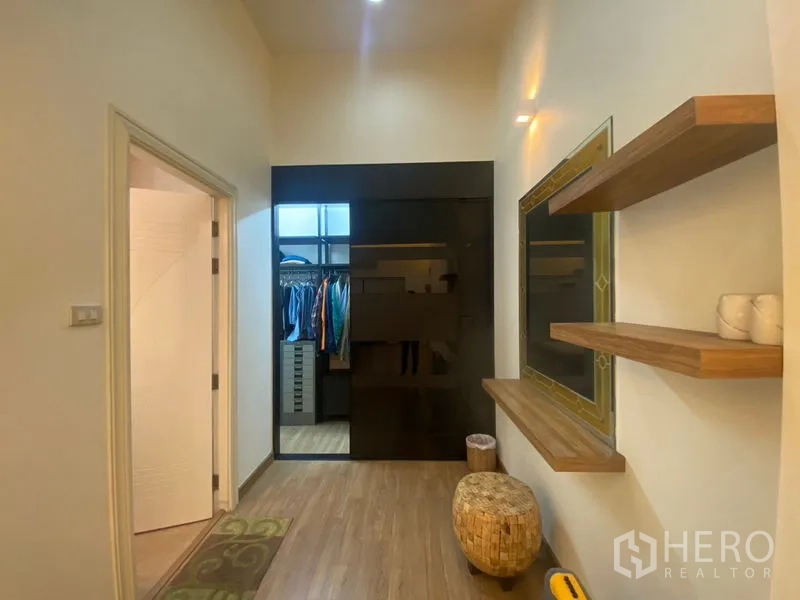 Detached House for sale in Khlong Toei, Bangkok - Walk-in closet area with sliding doors, open shelving, and wood floors.