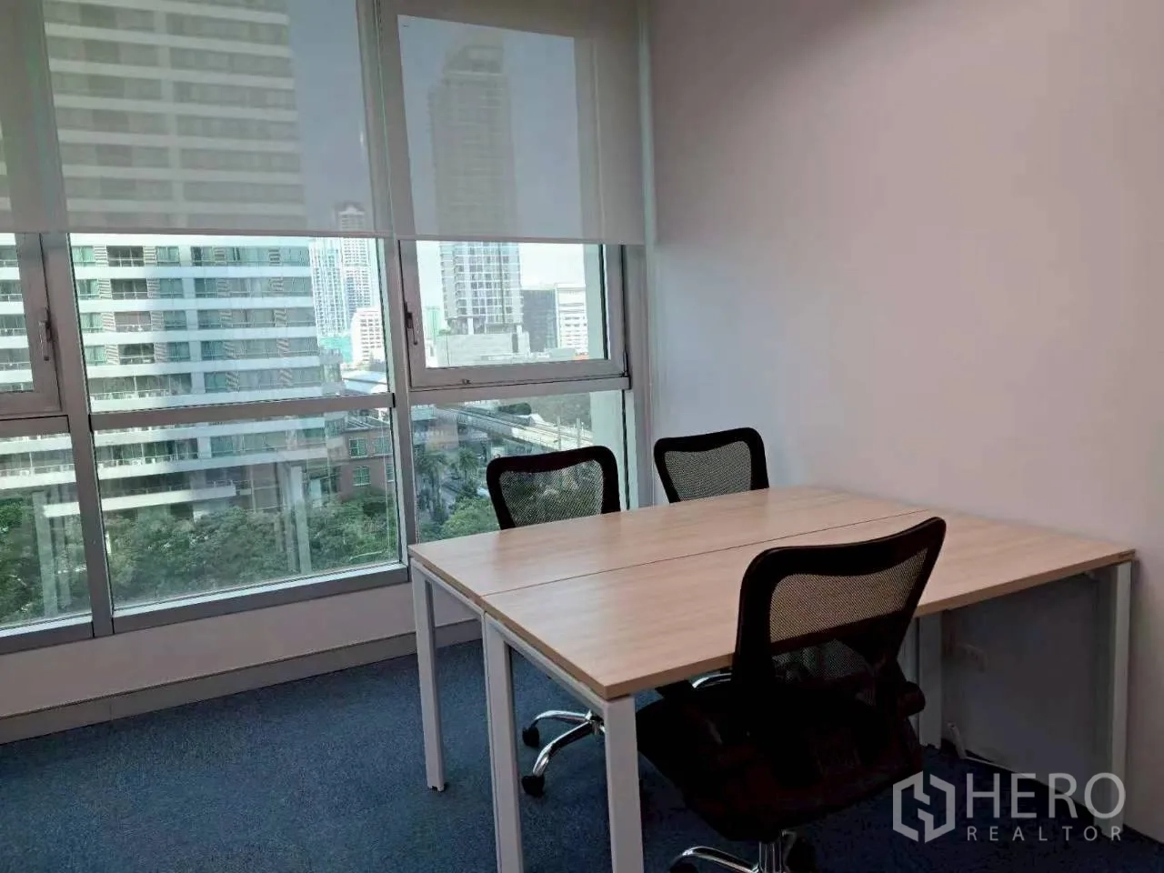 Office Space for rent in Sathon, Bangkok - Compact meeting room with two workstations, mesh chairs and skyline view.