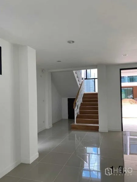 Home Office for rent or sale in Bang Phli, Samut Prakan - Entry hall with staircase and tiled floors offering flexible reception or lobby space.