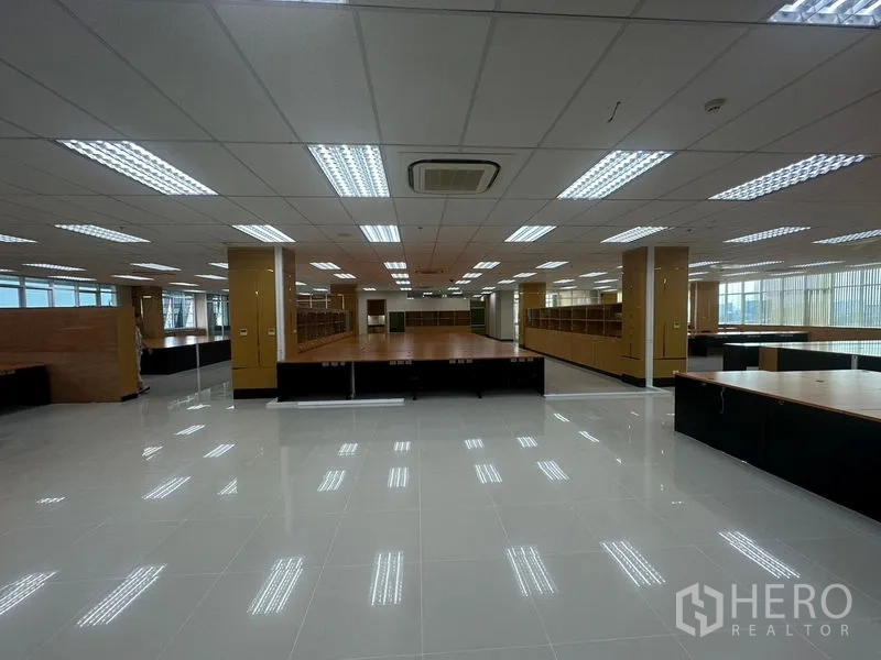 Office Space for rent in Suan Luang, Bangkok - Panoramic view across the office floor with multiple bench desks and bright ceiling lights.