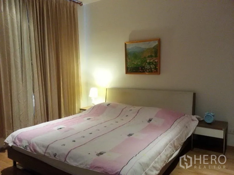 Condominium for rent in Sathon, Bangkok - Cozy bedroom with a large bed, bedside tables, warm lighting, and full-length curtains.