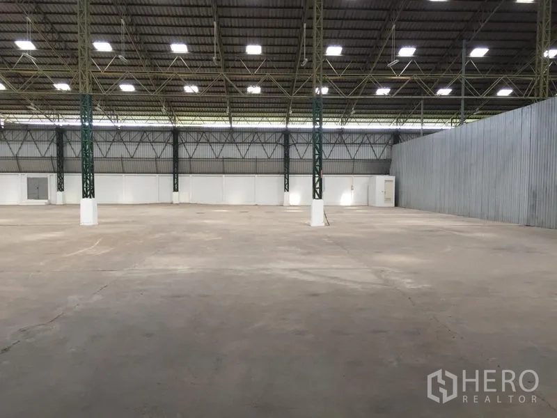 货栈 出租在Mueang Pathum Thani, Pathum Thani - 开阔货物区，柱距宽，隔热屋面与白色分隔墙