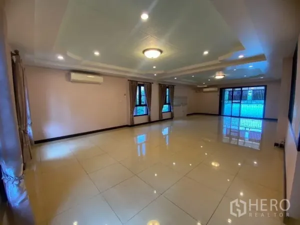Home Office for rent in Don Mueang, Bangkok - Spacious tiled living or meeting hall with recessed ceiling lights and windows.