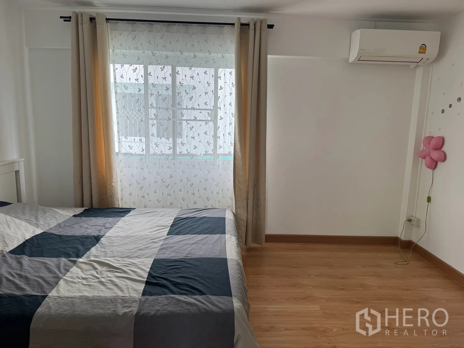 Detached House for rent in Saphan Sung, Bangkok - Bedroom with large bed, sheer drapes, and wall-mounted air conditioner.