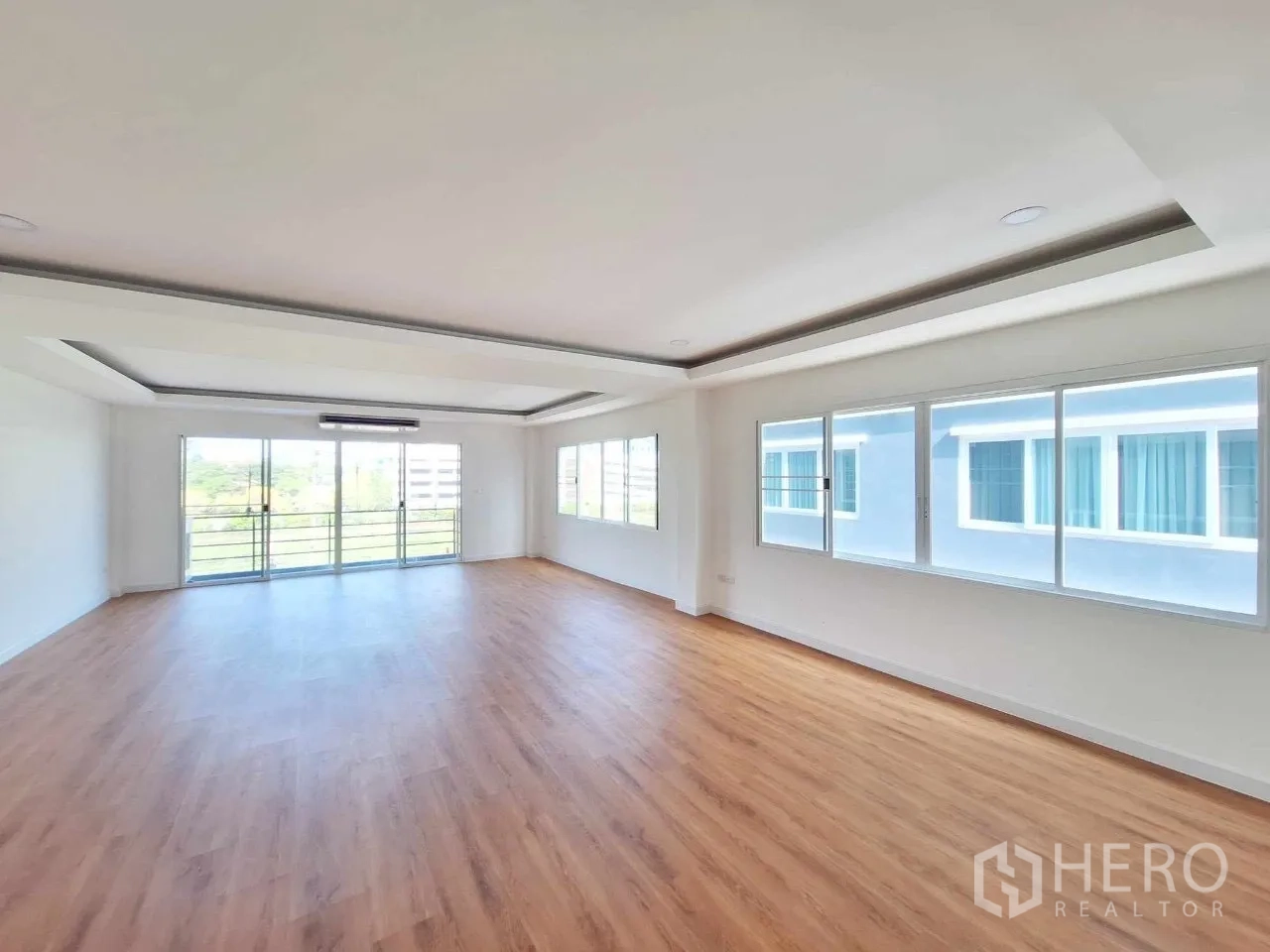 Home Office for sale in Bueng Kum, Bangkok - Sunlit office level with full-height windows and sliding balcony doors.