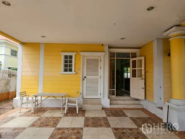 Detached House for rent or sale in Bang Lamung, Chon Buri - Covered front porch with patterned tiles and white entry door.