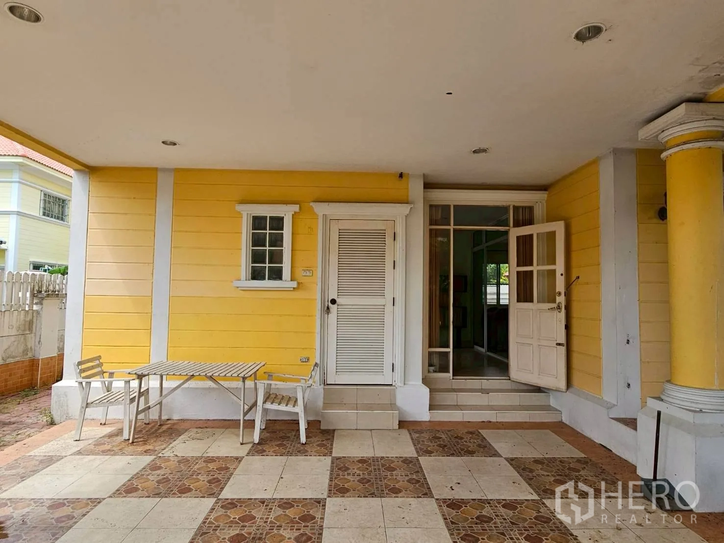 Detached House for rent or sale in Bang Lamung, Chon Buri - Covered front porch with patterned tiles and white entry door.