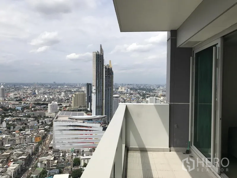 Condominium for rent or sale in Khlong San, Bangkok - Private balcony with glass doors facing ICONSIAM and river views from a high-rise unit.