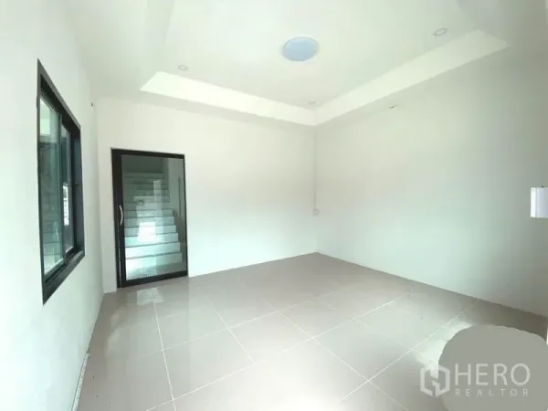 Warehouse for rent in Lat Lum Kaeo, Pathum Thani - Bright tiled office room with recessed ceiling, window and a glass door to the stairway.