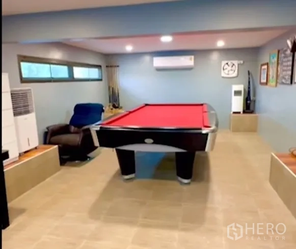 Detached House for sale in Bang Bua Thong, Nonthaburi - Entertainment room with pool table and recliner under recessed lighting.