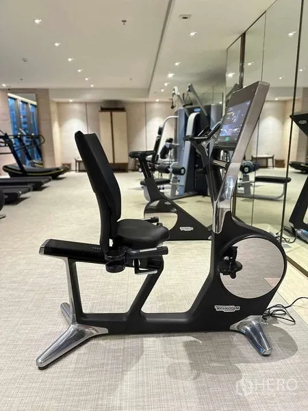 Condominium for sale - Fitness center with Technogym recumbent bike and mirrors.