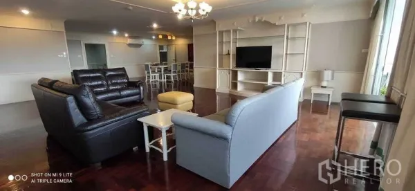 คอนโด ให้เช่าในWatthana, Bangkok - ห้องนั่งเล่นขนาดใหญ่ โซฟา ชั้นบิวท์อินวางทีวี และโคมระย้า