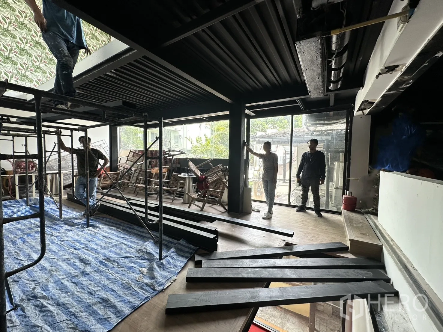 Retail Space for rent in Watthana, Bangkok - Upper floor under renovation with scaffolding, wide windows, and wood flooring.