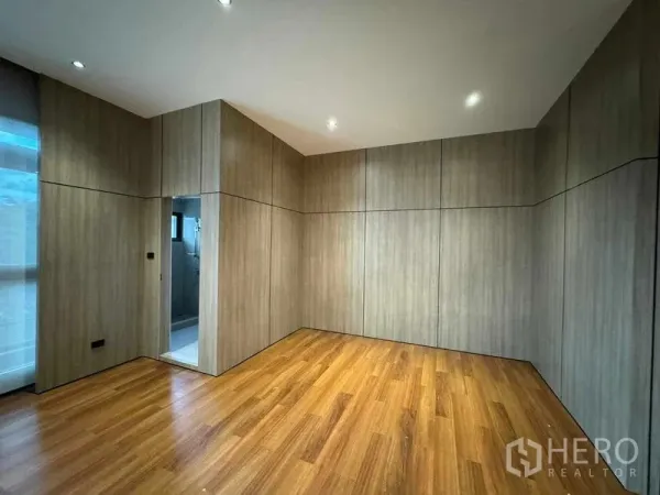 Home Office for rent or sale in Bang Phli, Samut Prakan - Wood‑panelled private room with timber floor and an ensuite bathroom doorway.