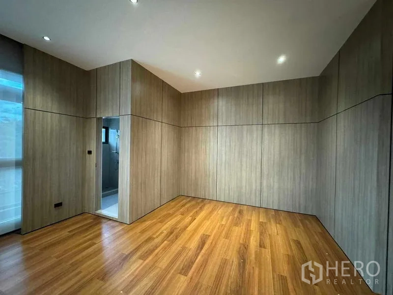 Home Office for rent or sale in Bang Phli, Samut Prakan - Wood‑panelled private room with timber floor and an ensuite bathroom doorway.