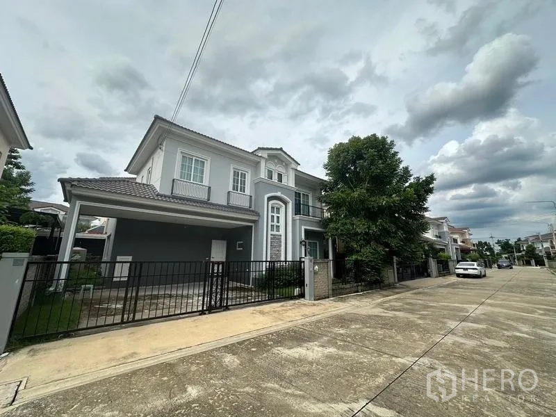 Detached House for sale in Bang Khen, Bangkok - Quiet residential street view of similar two-storey homes in the estate.