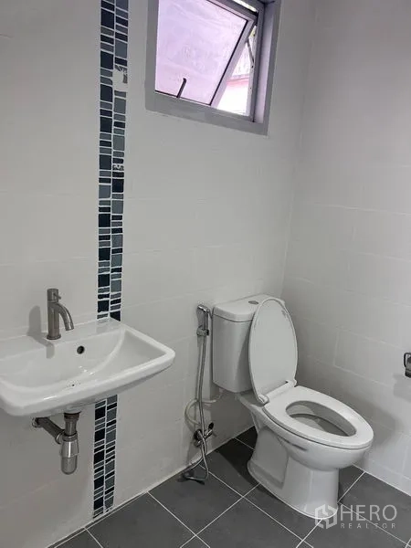 Home Office for sale in Lat Krabang, Bangkok - Bathroom with toilet, wall sink, bidet spray and a small ventilation window.