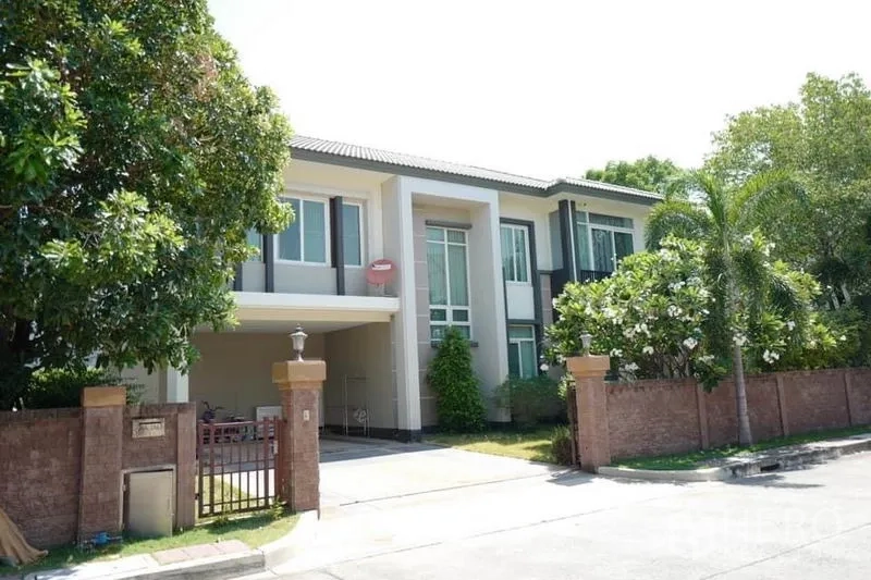 Detached House for sale in Pak Kret, Nonthaburi - Modern two-storey detached house with gated driveway, carport and mature trees.