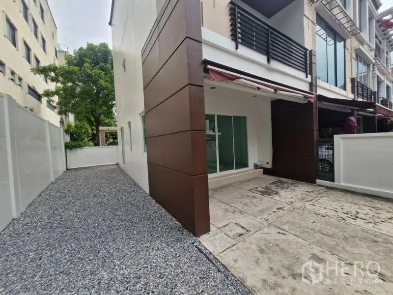 独立式住宅 出售在Rat Burana, Bangkok - 私家庭院侧廊，碎石步道与前方有顶停车位