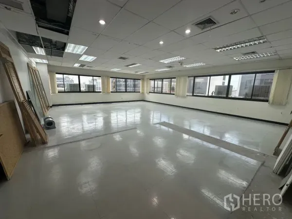 Office Space for rent in Khlong Toei, Bangkok - Spacious 84 sqm office floor with large windows on two sides and easy-care tiled flooring.