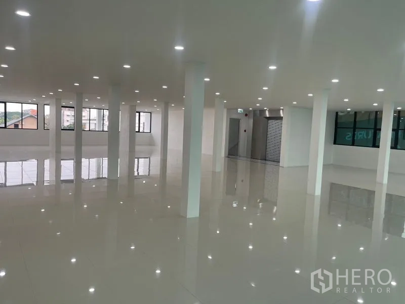 Home Office for rent or sale in Wang Thonglang, Bangkok - Open office floor with multiple columns and glossy tiles.