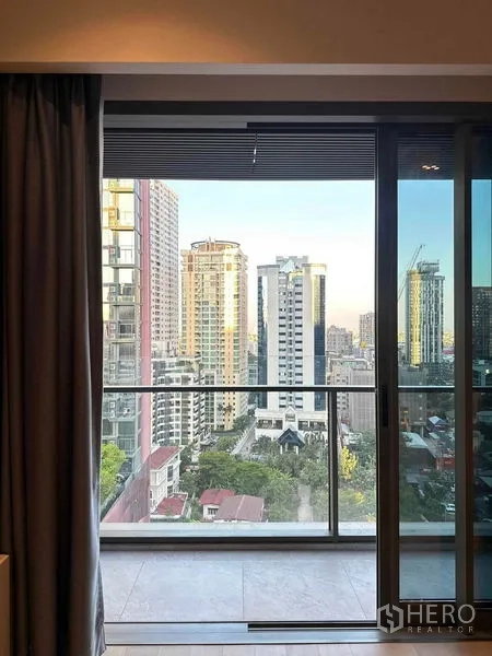 Condominium for sale - City skyline seen through sliding glass doors from the condo bedroom.