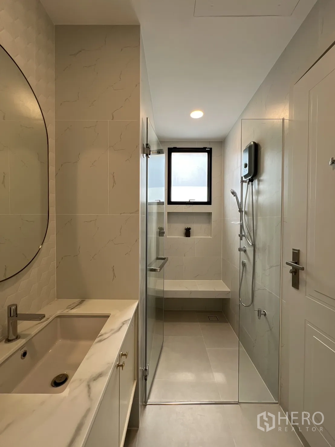 Detached House for rent in Saphan Sung, Bangkok - Bathroom with marble‑look vanity and glass-enclosed shower.