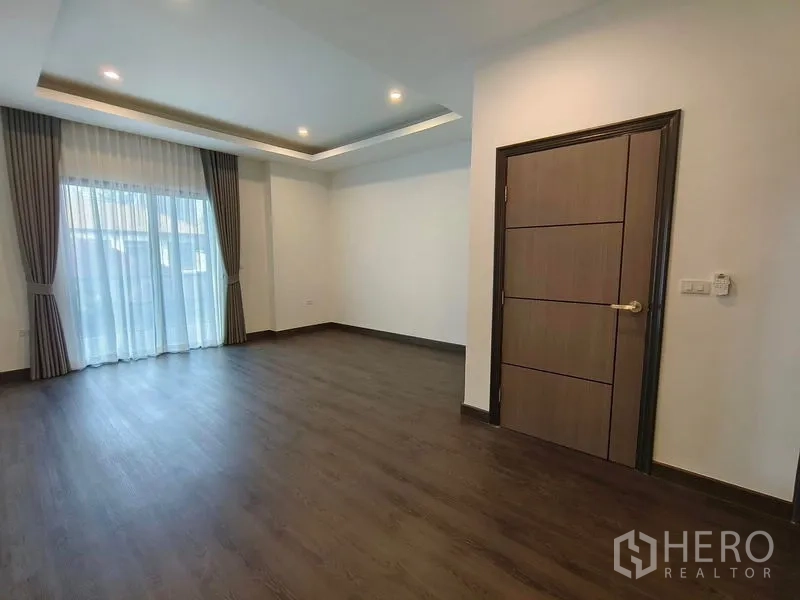 Detached House for rent or sale - Bright bedroom with balcony access through sliding glass doors and layered curtains.