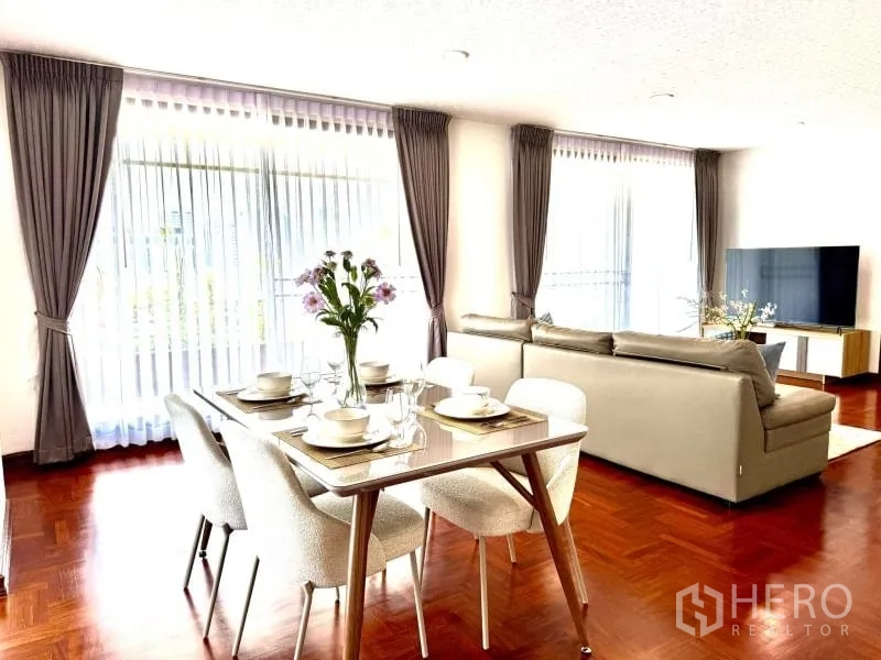 Condominium for rent - Bright dining and lounge with sheer curtains, TV console, and polished floors.